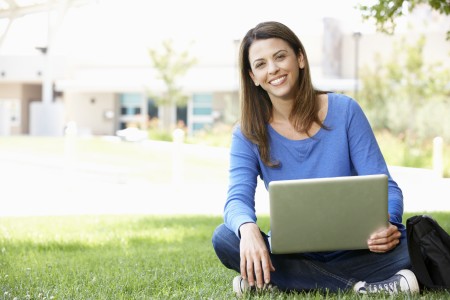 woman in blue shirt with a laptop