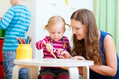 Child learning to draw in childcare