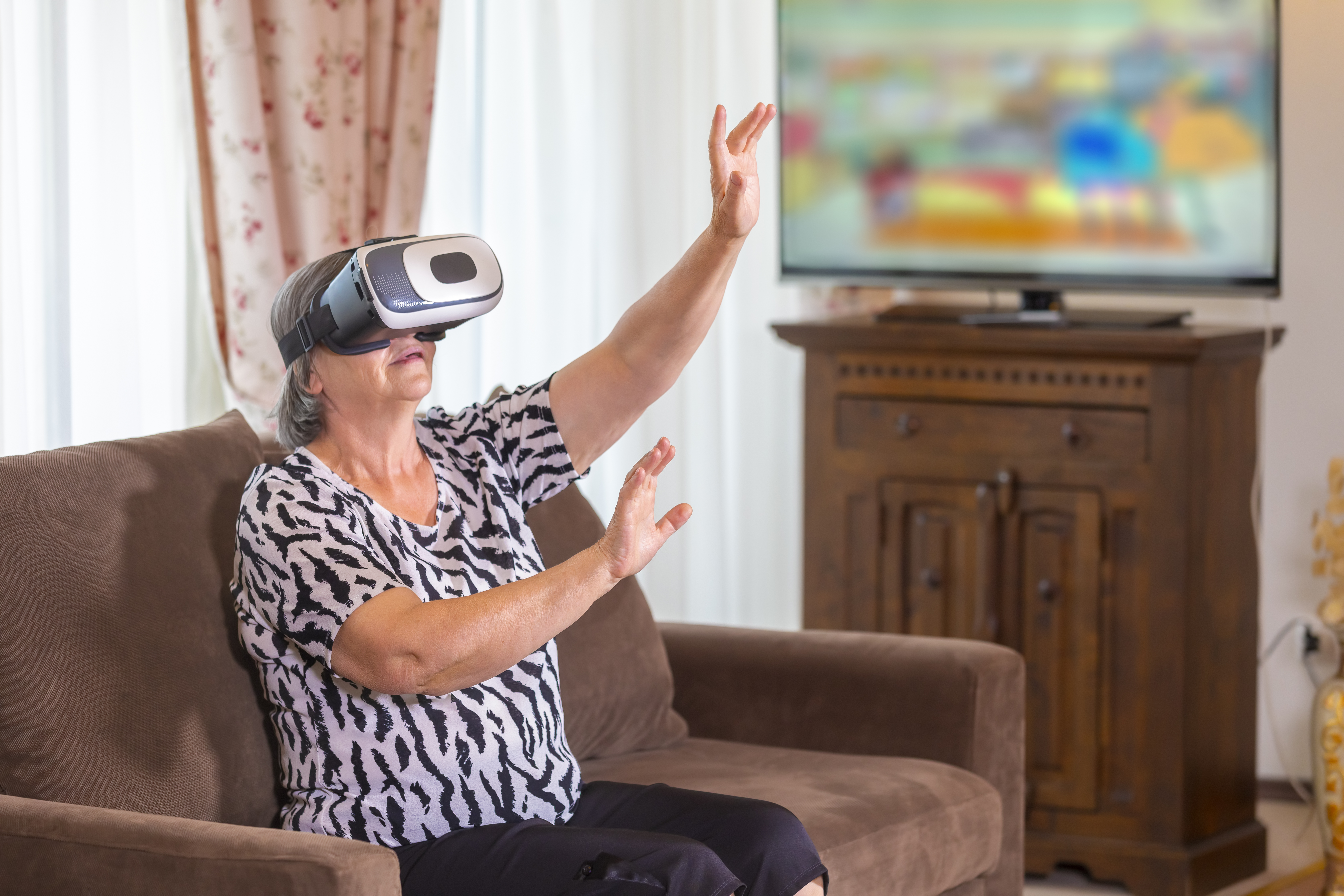Senior woman using virtual reality headset